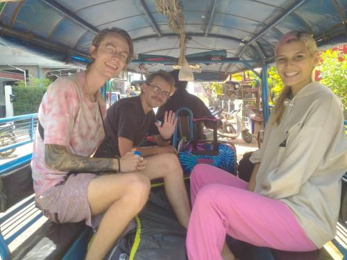 a group of three people sitting on a bus at Rainbow Hotel Vientiane in Vientiane