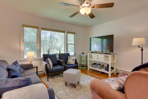 a living room with couches and a flat screen tv at Kiamesha Lake Home with Deck 4 Mi to Resorts World! in Monticello