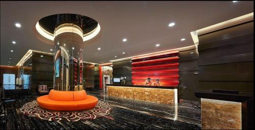 a lobby with an orange bench in a building at Cititel Express Penang in George Town