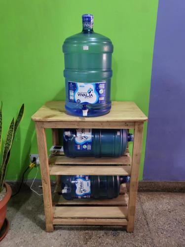 a large bottle of water sitting on a wooden table at Alojamiento San Francisco - Apartamentos y habitaciones in Lima