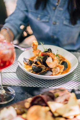 a plate of food with shrimp and mussels on a table at L'Auberge De Sedona in Sedona