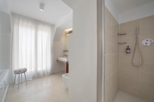 a bathroom with a shower and a toilet and a sink at Fantinello Hotel in Caorle