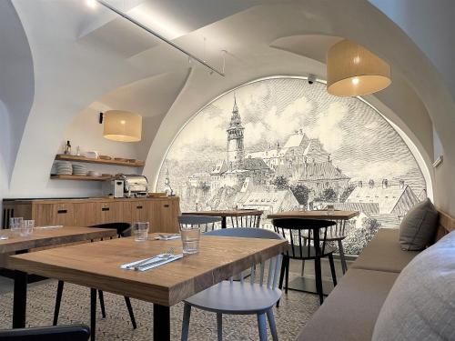 a restaurant with a mural on the wall at Penzion KOVÁRNA in Český Krumlov