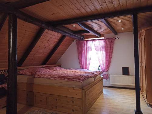 a attic bedroom with a bed and a window at Ferienwohnung "Frieda" in Breitenstein
