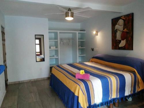 a bedroom with a bed with a pink box on it at Casa Elena a unos pasos de la playa Lo de Marcos in Lo de Marcos