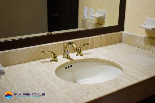 a bathroom counter with a sink and a mirror at Marina Pinacate A-520 in Puerto Peñasco