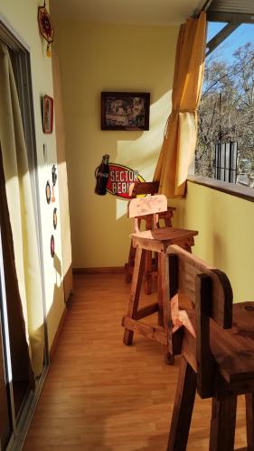 a room with a wooden bench and a window at Yellow in San Martín