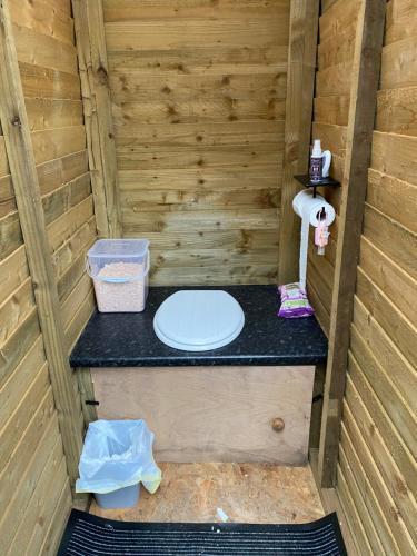 a toilet in the inside of a wooden sauna at The Haystack in Oswestry