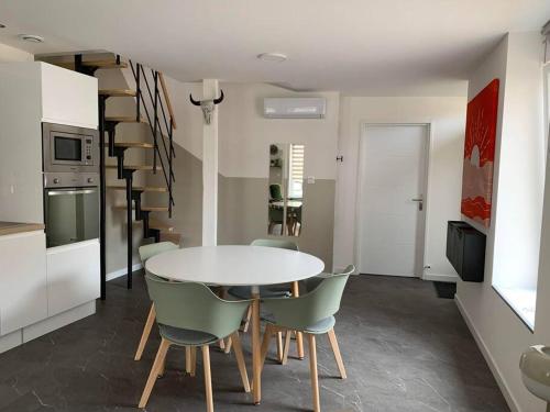 a kitchen and dining room with a table and chairs at Maison individuelle in Vincey