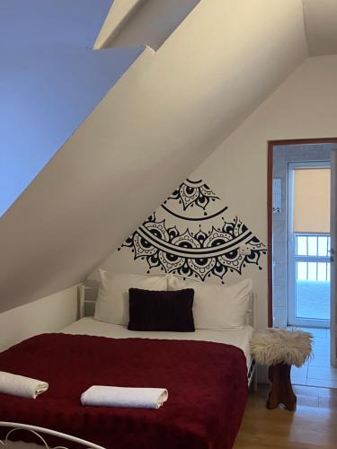 a bedroom with a bed with a red blanket at Mała Bawaria in Zakopane