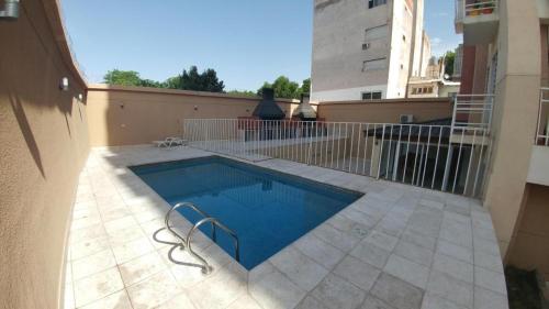 a swimming pool on a patio next to a building at Departamento a 1 cuadra de calle Aristides in Mendoza