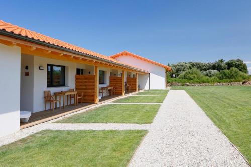 a house with a green lawn in front of it at Apartamentos Aronces in Cudillero