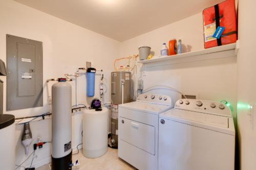 a kitchen with a washer and dryer in a room at Waterfront Hartfield Vacation Rental with Dock! in Hartfield
