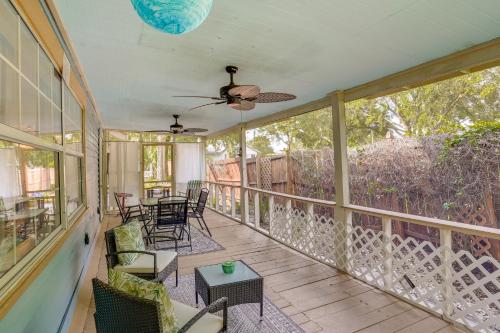 a screened porch with chairs and a ceiling fan at Lake Wales Vacation Rental with Screened-In Porch! in Lake Wales