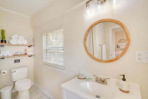 a bathroom with a toilet and a sink and a mirror at Lake Wales Vacation Rental with Screened-In Porch! in Lake Wales