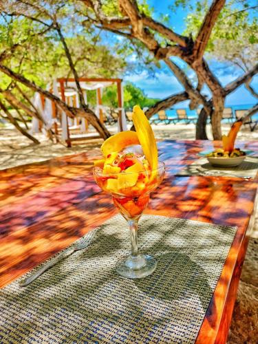 a glass with fruit in it sitting on a table at Hotel Rosario de Mar by Tequendama in Isla Grande