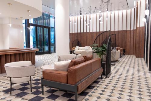 a waiting room with a couch and chairs at Motto By Hilton New York City Times Square in New York