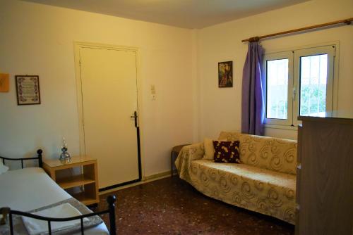 a living room with a couch and a window at Gianna Seaside in Koutsounari