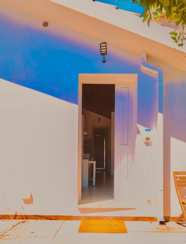 a white wall with a door into a room at La Caletta di Afrodite in Calabernardo