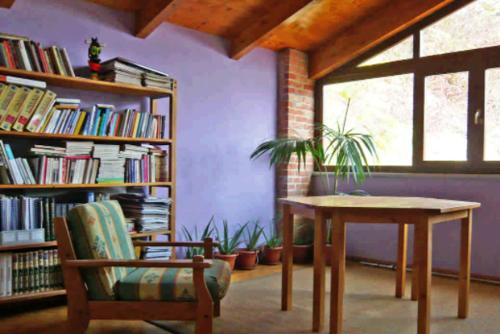 a room with a table and a book shelf with books at B&B Locanda della Sesta Felicità in Vaglio Serra