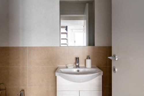 a bathroom with a sink and a mirror at La Caletta di Afrodite in Calabernardo