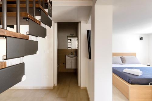a small bedroom with a bed and a bathroom at La Caletta di Afrodite in Calabernardo