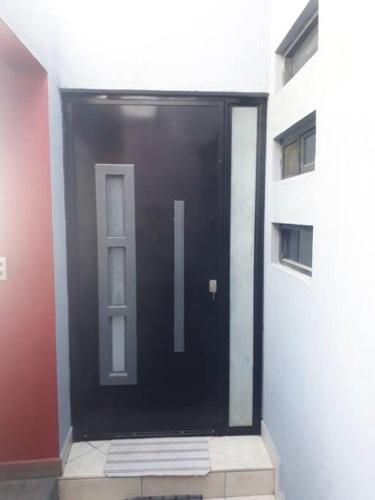 a black door in a building with a window at Casa Hogareña las estacas in Barranca Honda