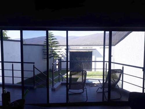 a view of a balcony with two chairs and a table at Casa Hogareña las estacas in Barranca Honda