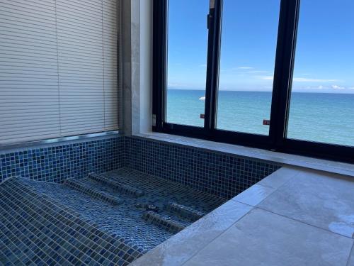 a bathroom with a shower with a view of the ocean at Haon Terrace Suite Villa Ango - Vacation STAY 30531v in Sumoto