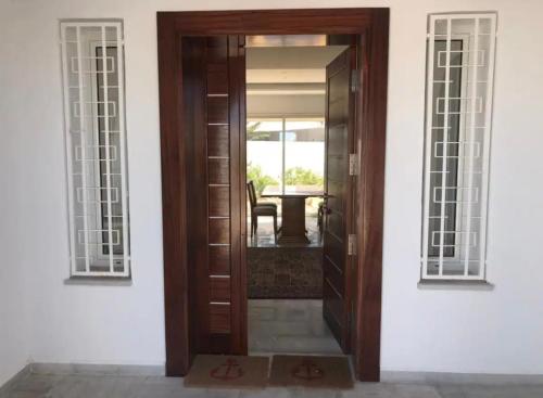 a wooden door with two windows on a house at Villa Lucia in Djerba