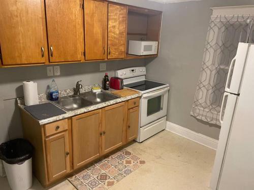 a small kitchen with a sink and a refrigerator at Bennington stay in Bennington