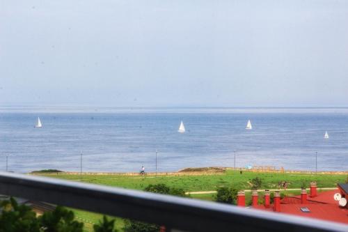 a view of the ocean with sailboats in the water at Junto a las playas,dos terrazas y vistas al mar in Sopelana