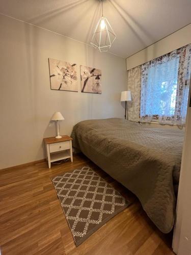 a bedroom with a large bed and a window at APt 37 in Rovaniemi