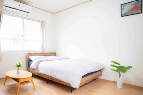 1 dormitorio con cama, mesa y ventana en Katsushika-ku - House - Vacation STAY 15298, en Tokio