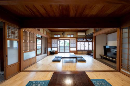 a living room with a table in a room with windows at Setouchi base - Vacation STAY 48109v in Mitoyo