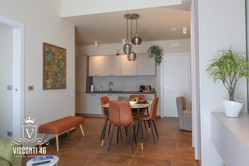 a kitchen and dining room with a table and chairs at Visconti 46 Central Apartments in Bari