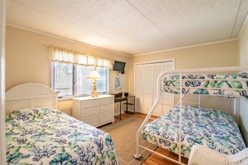 a bedroom with a bunk bed and a desk at 5732 - Beach Music in Nags Head