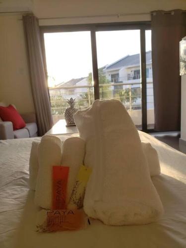 a pile of towels sitting on top of a bed at Convenient Studio Apt Near Airport, Beaches & Food in Cupecoy
