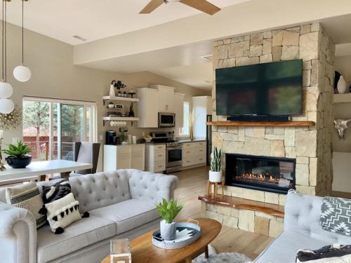 a living room with a couch and a fireplace at ULTIMATE Mountain Escape with Pool & Hot Tub & Firepit in Sedona