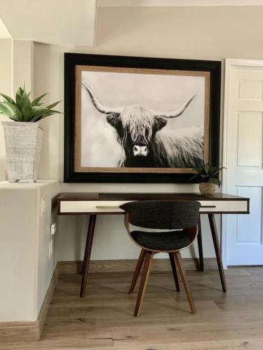 a desk with a picture of a cow at ULTIMATE Mountain Escape with Pool & Hot Tub & Firepit in Sedona