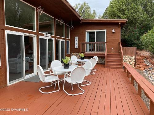 a wooden deck with a table and chairs on a house at ULTIMATE Mountain Escape with Pool & Hot Tub & Firepit in Sedona