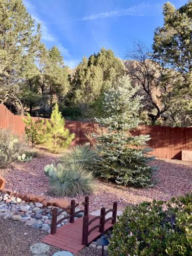 a garden with a wooden bench in a yard at ULTIMATE Mountain Escape with Pool & Hot Tub & Firepit in Sedona