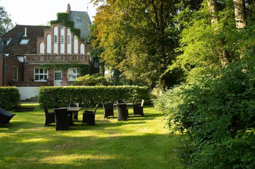 a row of tables and chairs in a park at Hotel Gut Bardenhagen in Bardenhagen