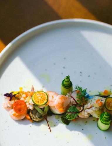 a plate of food with shrimp and vegetables on it at Casa Amigos - By Pura Villas in Dominical
