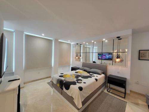 a bedroom with a bed and a flat screen tv at Marbella edificio Puerto Azul in Marbella