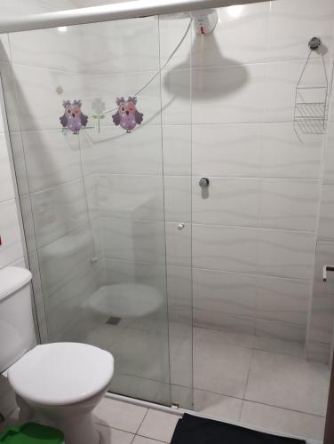 uma casa de banho com um WC e uma cabina de duche em vidro. em FLORIPA FLORINDO APART em Florianópolis