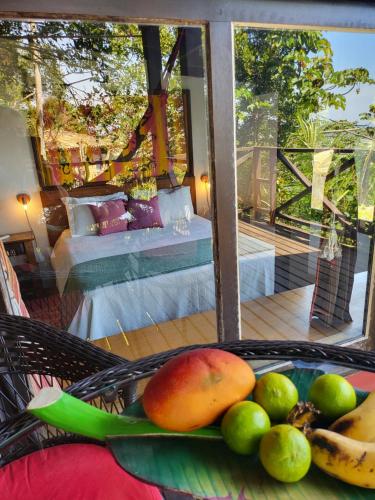 a basket of fruit on a table in a bedroom at La Roca Studio 7 in Praia do Rosa