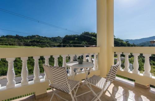 a patio with a table and chairs on a balcony at Casa Cielo in Rincon