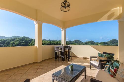 a living room with a balcony with a table and chairs at Casa Cielo in Rincon
