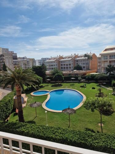 a view of a swimming pool in a park with buildings at Arenal in Jávea